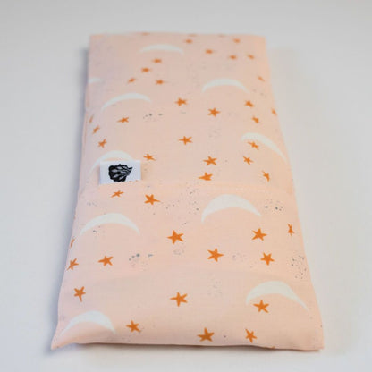 Pink moon and stars eye pillow on white background